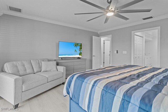 bedroom with light wood-type flooring, a closet, ceiling fan, and crown molding