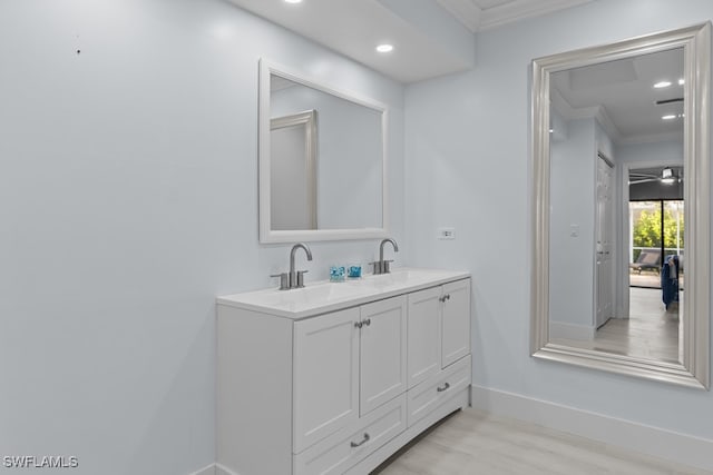 bathroom featuring hardwood / wood-style floors, vanity, and ornamental molding