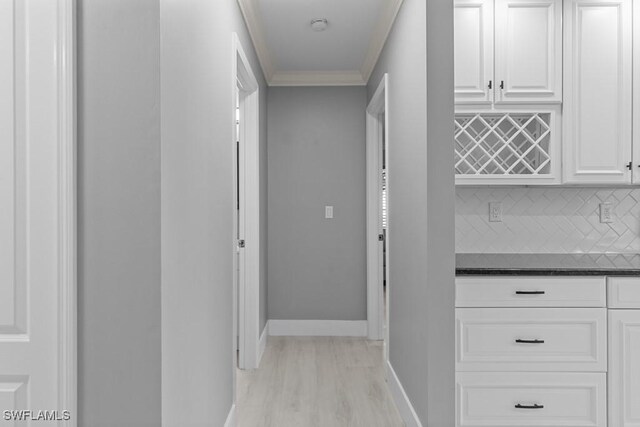 corridor featuring light hardwood / wood-style floors and ornamental molding