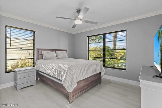 bedroom with multiple windows, ceiling fan, light hardwood / wood-style flooring, and ornamental molding