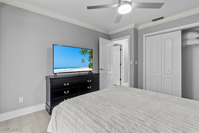 bedroom featuring ceiling fan, crown molding, and a closet