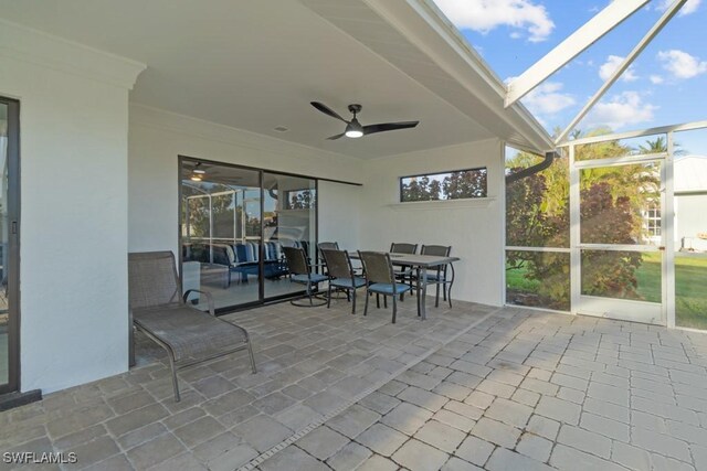 sunroom featuring ceiling fan