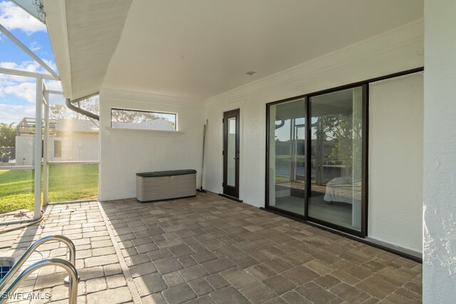 view of patio with glass enclosure