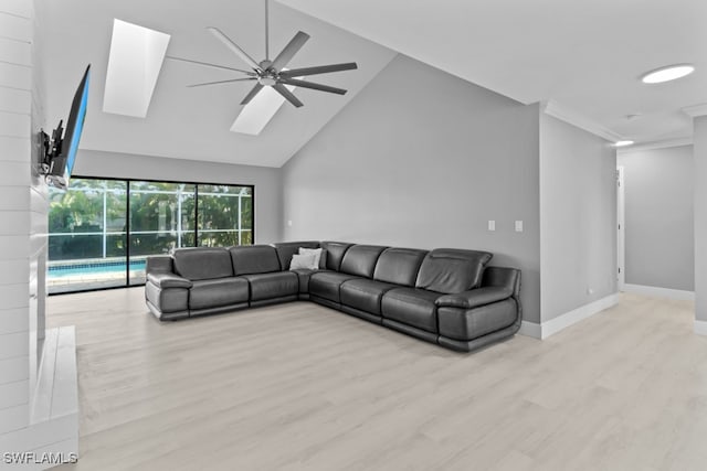 living room featuring light hardwood / wood-style floors, high vaulted ceiling, and ceiling fan