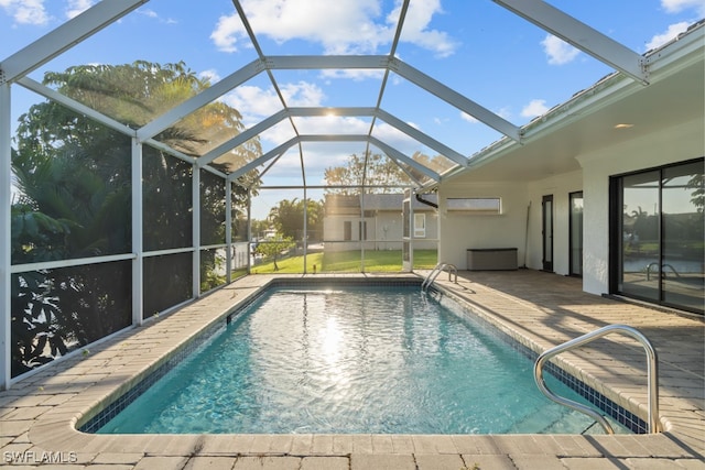 view of swimming pool with a lanai and a patio area