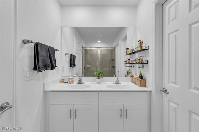 bathroom featuring vanity and a shower with shower door