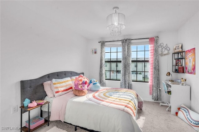 carpeted bedroom featuring an inviting chandelier