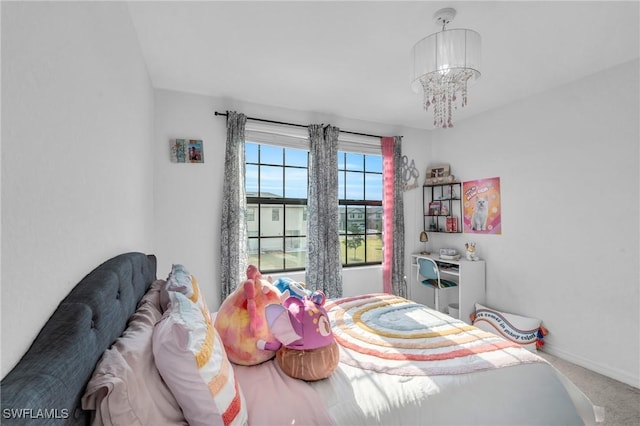 carpeted bedroom featuring a chandelier