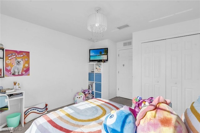 bedroom with a closet and an inviting chandelier