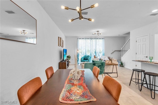 tiled dining space featuring a notable chandelier