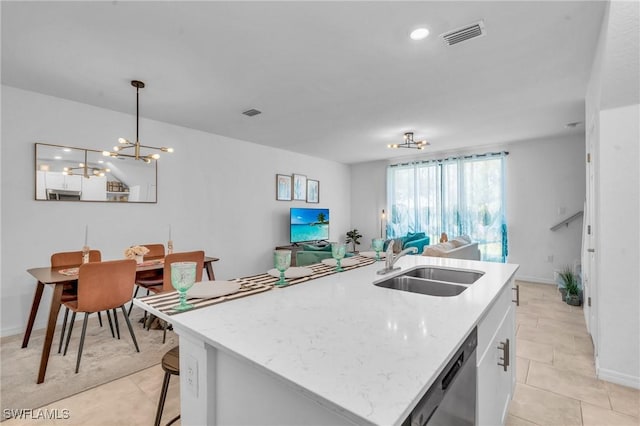 kitchen with sink, decorative light fixtures, a center island with sink, dishwasher, and white cabinetry