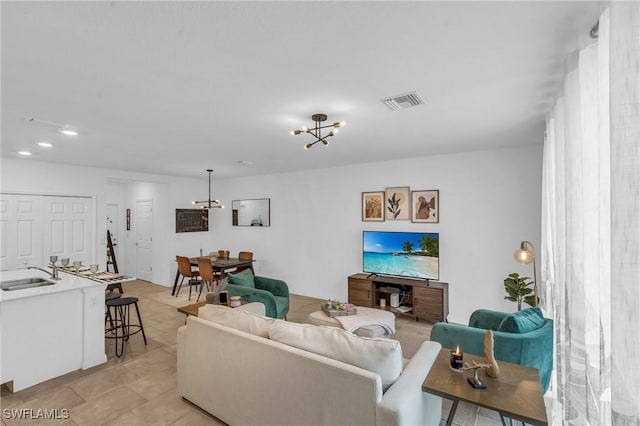 living room with sink and a chandelier