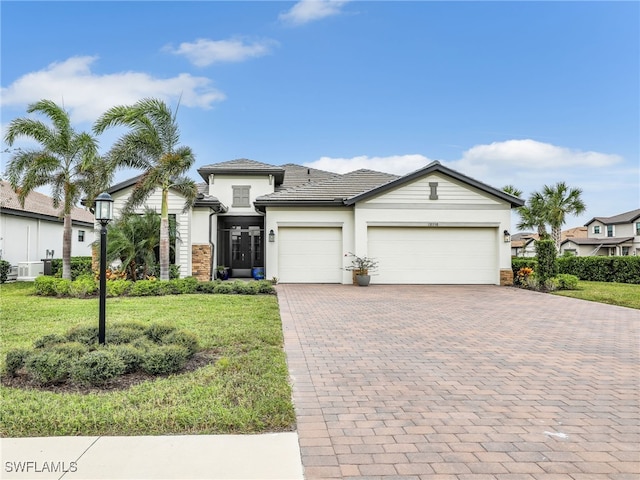 view of front of house featuring a front yard and a garage