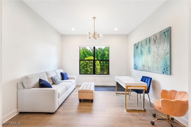 living room with an inviting chandelier and wood-type flooring