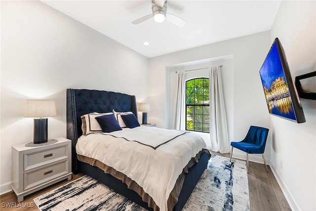 bedroom with ceiling fan and light hardwood / wood-style floors