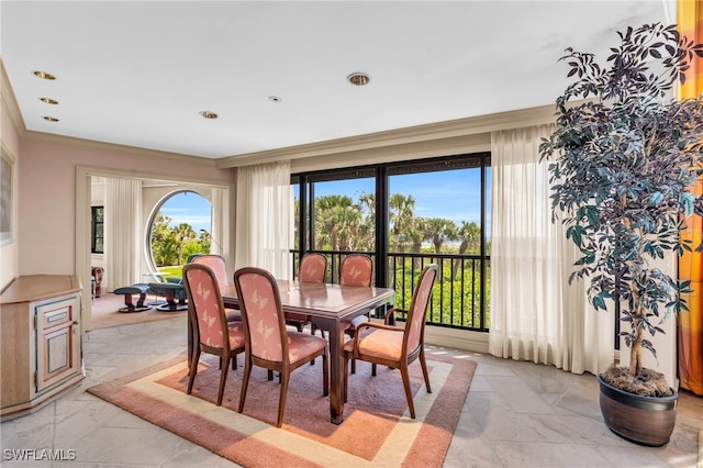 dining space featuring crown molding