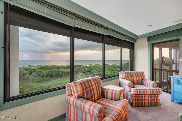 sunroom / solarium featuring a water view