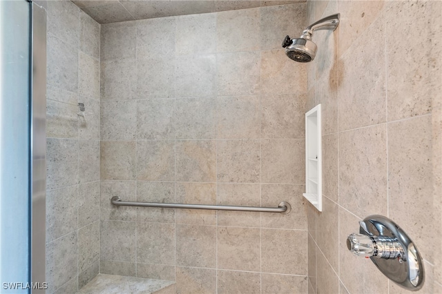 bathroom with tiled shower