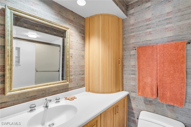 bathroom with toilet and vanity