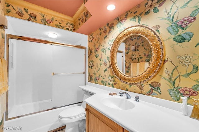 full bathroom featuring toilet, vanity, and bath / shower combo with glass door