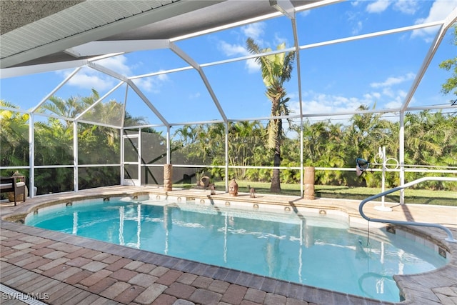 view of swimming pool featuring a lanai