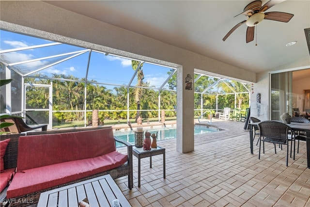 sunroom / solarium featuring vaulted ceiling, ceiling fan, and a swimming pool