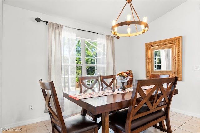 tiled dining area with a chandelier