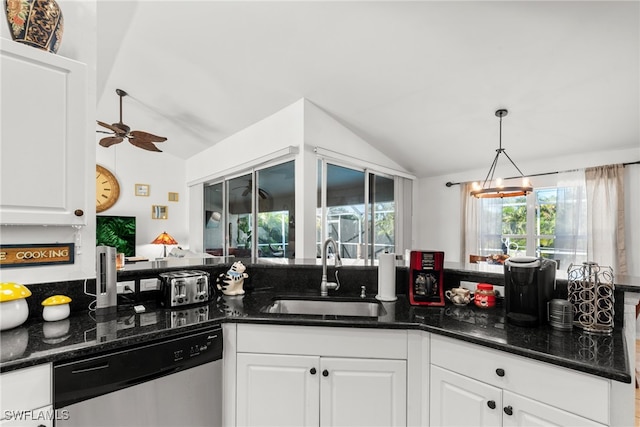 kitchen with stainless steel dishwasher, white cabinetry, lofted ceiling, and sink