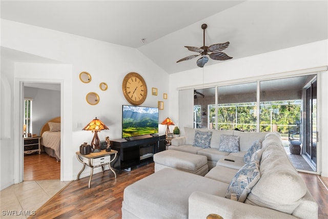 living room with wood-type flooring, ceiling fan, and lofted ceiling