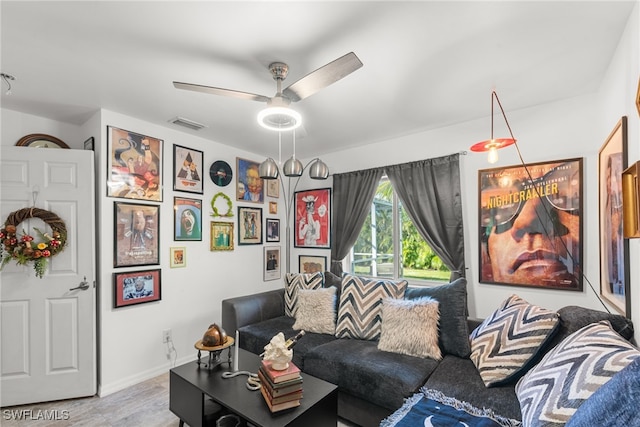 living room featuring ceiling fan and light hardwood / wood-style flooring