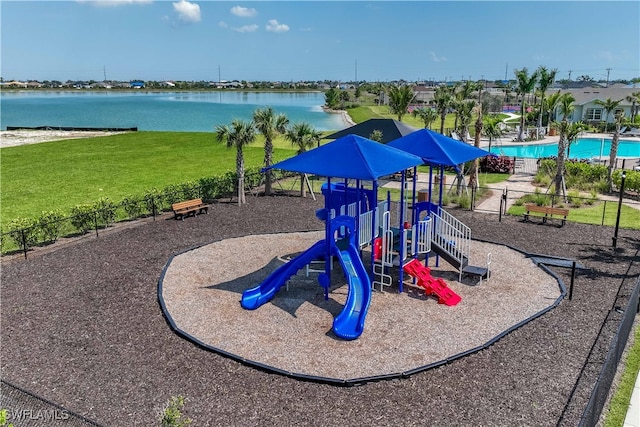 view of playground featuring a lawn and a water view