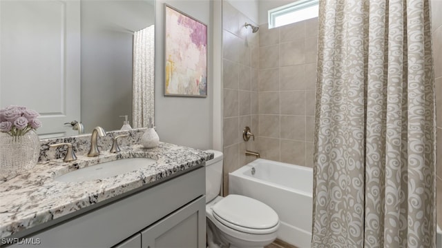 full bathroom with shower / bath combination with curtain, vanity, and toilet