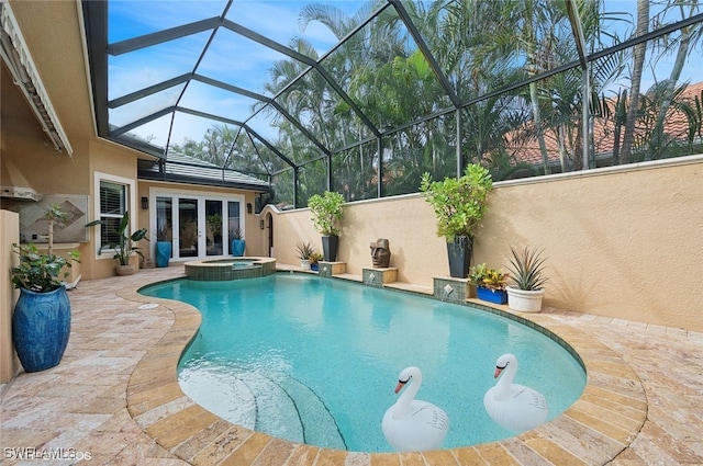 view of swimming pool with glass enclosure, an in ground hot tub, french doors, and a patio