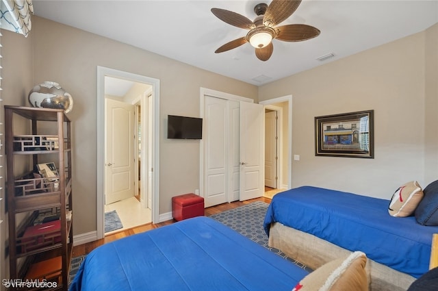 bedroom with a closet, ceiling fan, and hardwood / wood-style floors