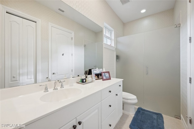 bathroom with tile patterned floors, vanity, toilet, and a shower with shower door