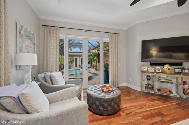 4908 Rustic Oaks Cir, Naples, FL 34105 - living room featuring wood finished floors, french doors, ornamental molding, and baseboards