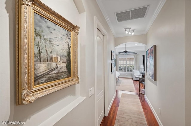 4908 Rustic Oaks Cir, Naples, FL 34105 - corridor featuring crown molding, wood finished floors, baseboards, and arched walkways