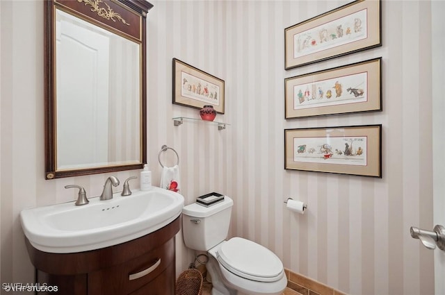 4908 Rustic Oaks Cir, Naples, FL 34105 - half bath with wallpapered walls, toilet, a sink, and baseboards