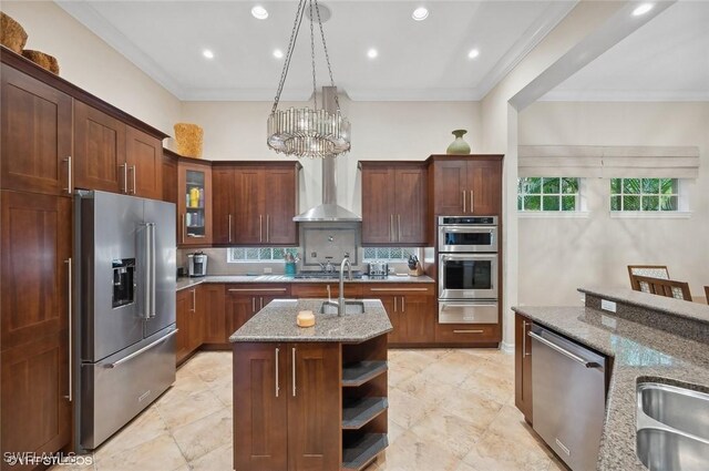 4908 Rustic Oaks Cir, Naples, FL 34105 - kitchen featuring stainless steel appliances, a warming drawer, a center island with sink, light stone countertops, and a chandelier