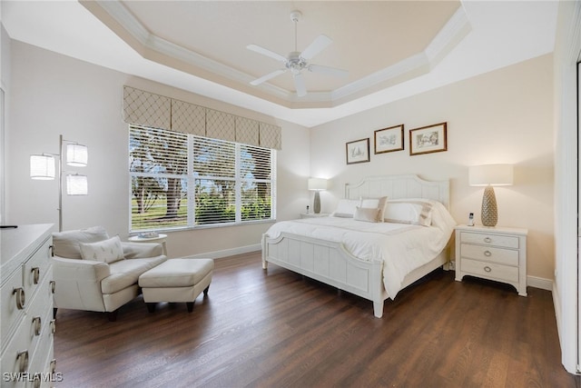 bedroom featuring a raised ceiling, ceiling fan, and dark hardwood / wood-style flooring