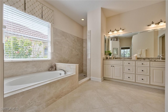 bathroom with tile patterned floors, vanity, and plus walk in shower