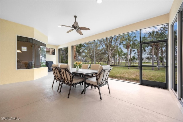 sunroom / solarium featuring ceiling fan