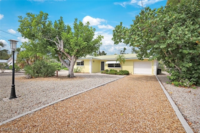 ranch-style house featuring a garage