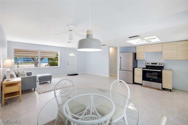 dining space featuring a skylight and ceiling fan