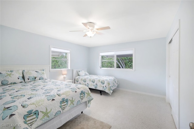 carpeted bedroom with a closet and ceiling fan