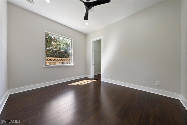 spare room with ceiling fan and dark hardwood / wood-style floors