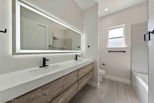 full bathroom with vanity, toilet, wood-type flooring, and separate shower and tub