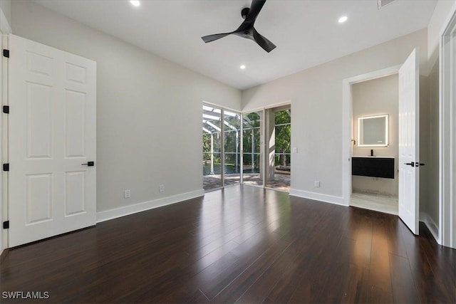 unfurnished bedroom featuring connected bathroom, access to exterior, dark wood-type flooring, and ceiling fan