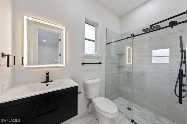 bathroom featuring vanity, toilet, and walk in shower