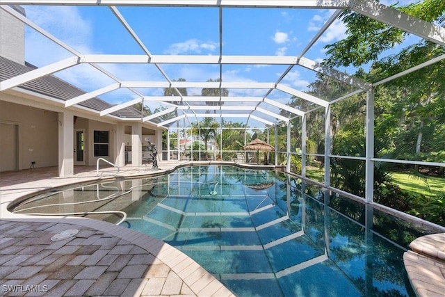 view of pool with a patio area and glass enclosure